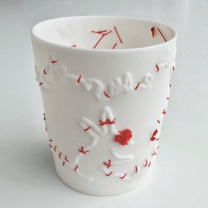 Porcelain beaker with silk hand stitching