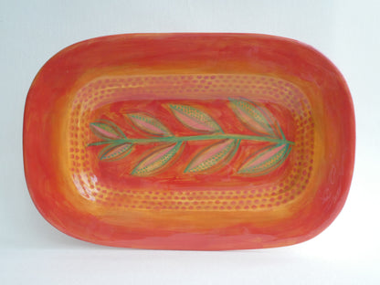 Long ceramic plate with leaf stem pattern
