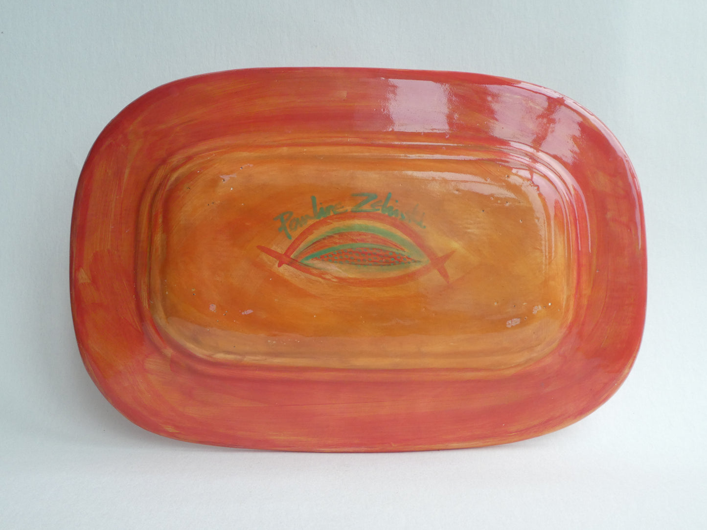Long ceramic plate with leaf stem pattern
