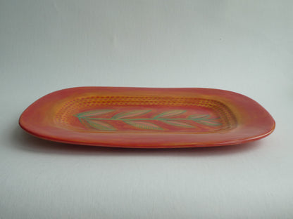 Long ceramic plate with leaf stem pattern